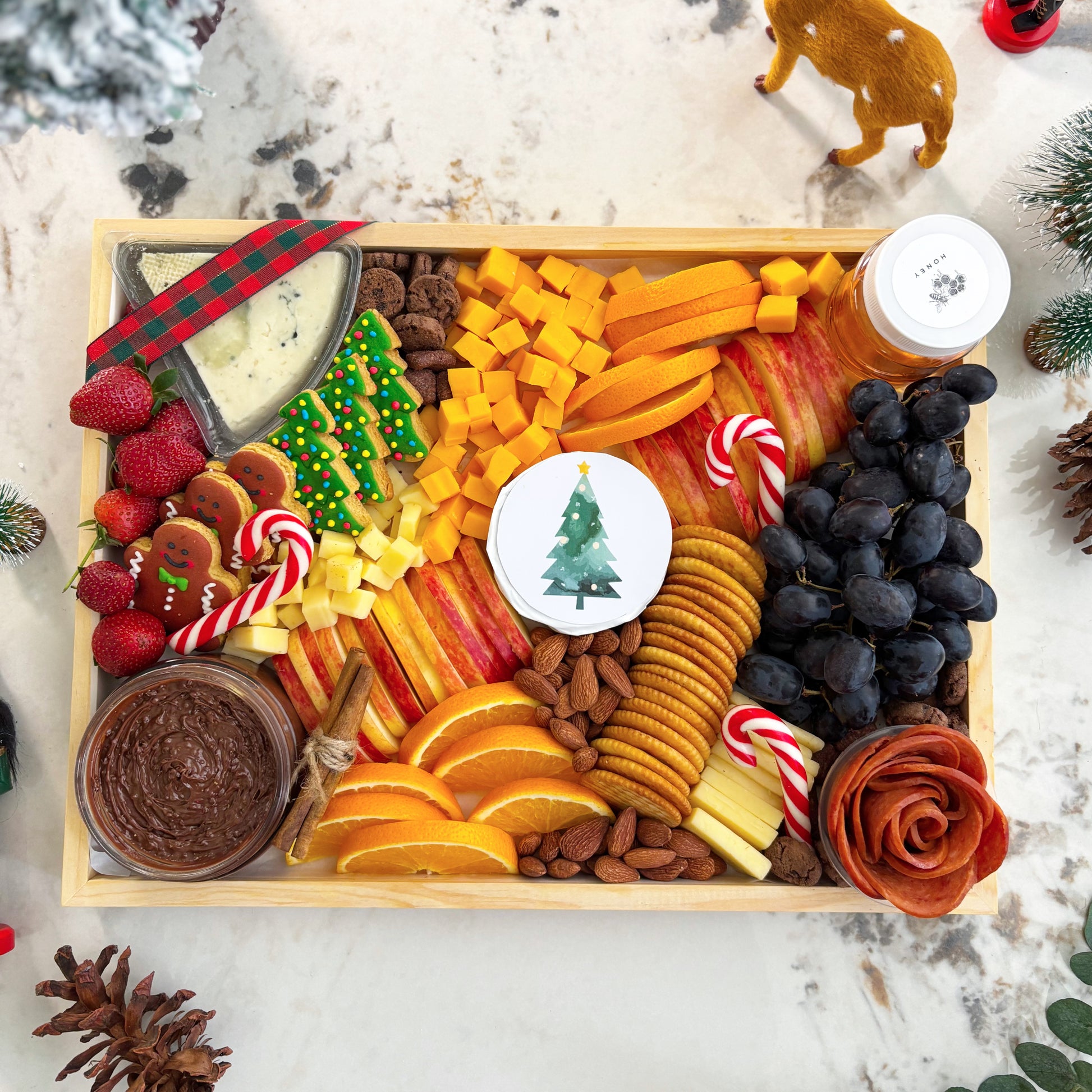 Decorative charcuterie board with fruits, cheeses, and nuts on a festive background. Christmas Xtra Cheese Platter | Best Cheese Platter in Jakarta & Surabaya – Le Bliss Platter