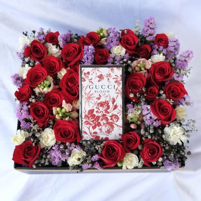 Floral arrangement with a Gucci Bloom box in the center on a white background. perfume hamper by le bliss. perfume hamper jakarta, surabaya, gucci hamper jakarta