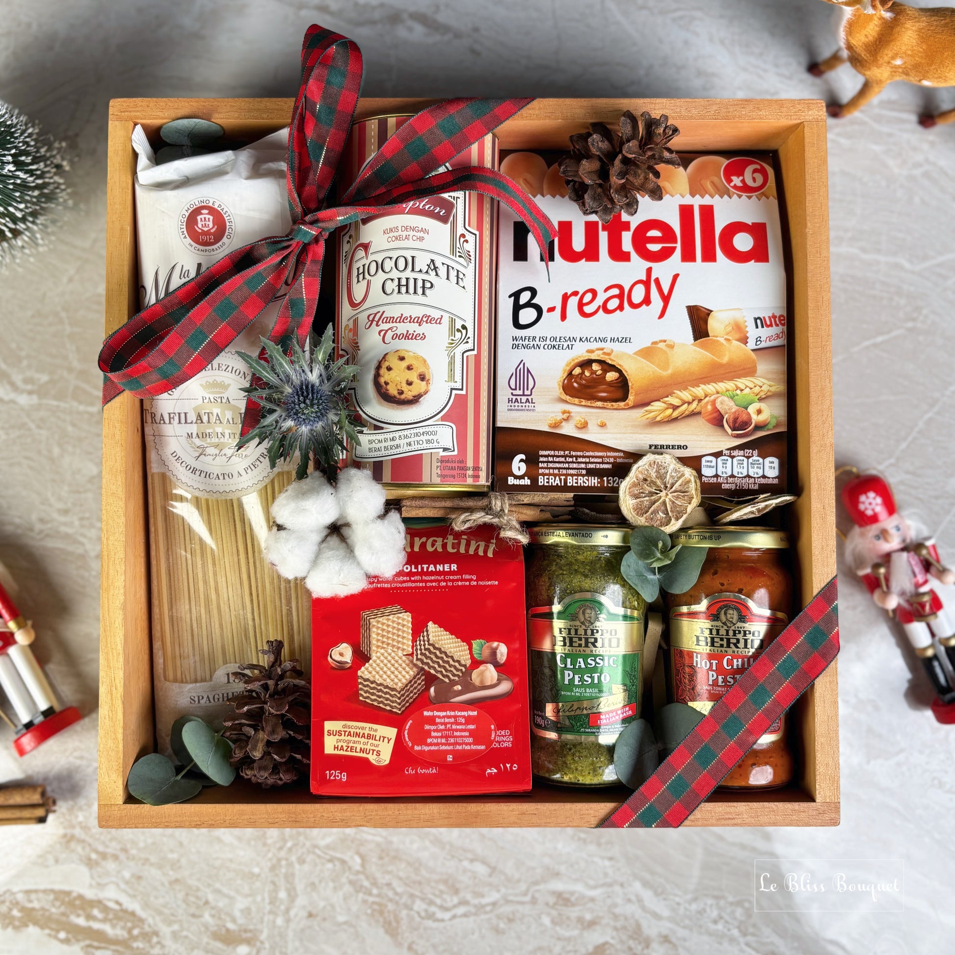 Gift basket with Nutella, cookies, pasta, and other items on a decorative surface. Gourmet Hamper Jakarta, Gourmet Hamper Surabaya, Christmas Hamper Jakarta, hamper natal jakarta, surabaya
