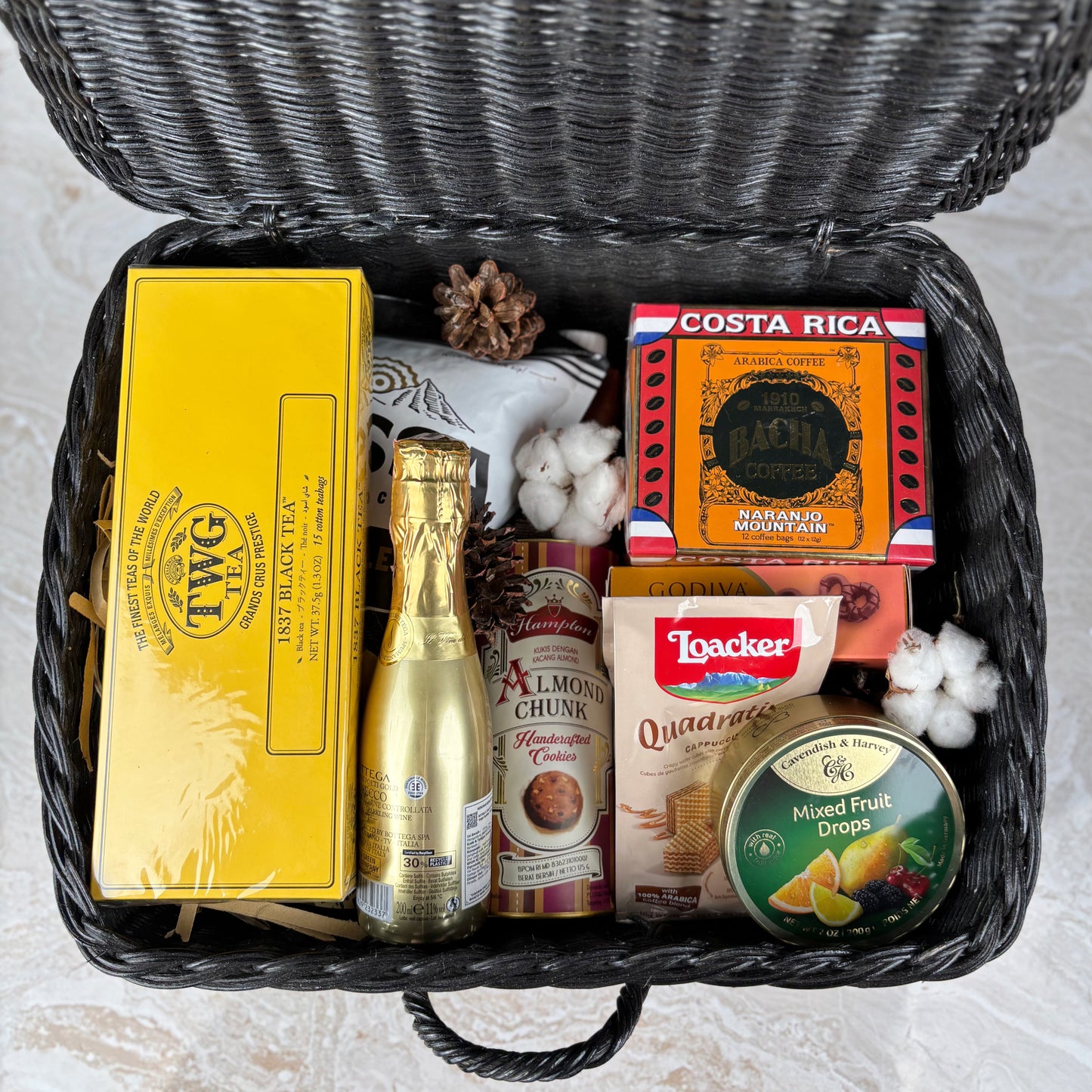 Gift basket with tea, chocolate, and other items by le bliss box. a premium snack gourmet hamper in jakarta, surabaya, cirebon