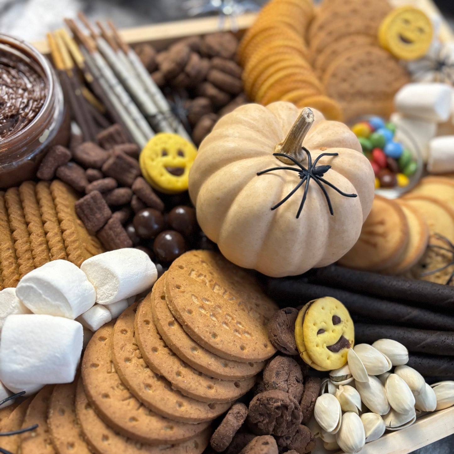 Halloween-themed cookie platter with cookies, candies, and decorative items by le bliss platter