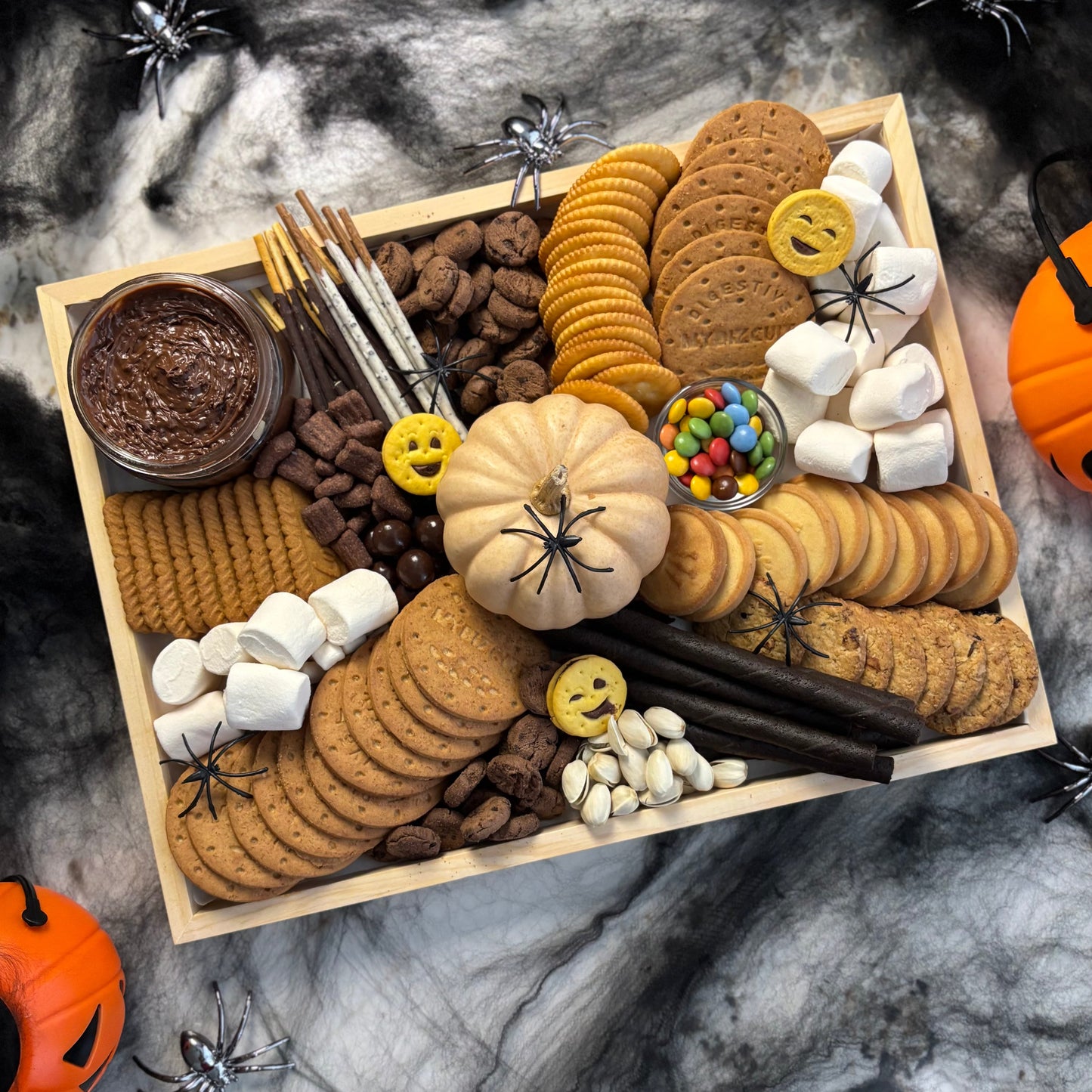 Halloween-themed cookie platter with various treats on a dark marble background. halloween sweet platter jakarta, halloween sweet platter surabaya by le bliss platter