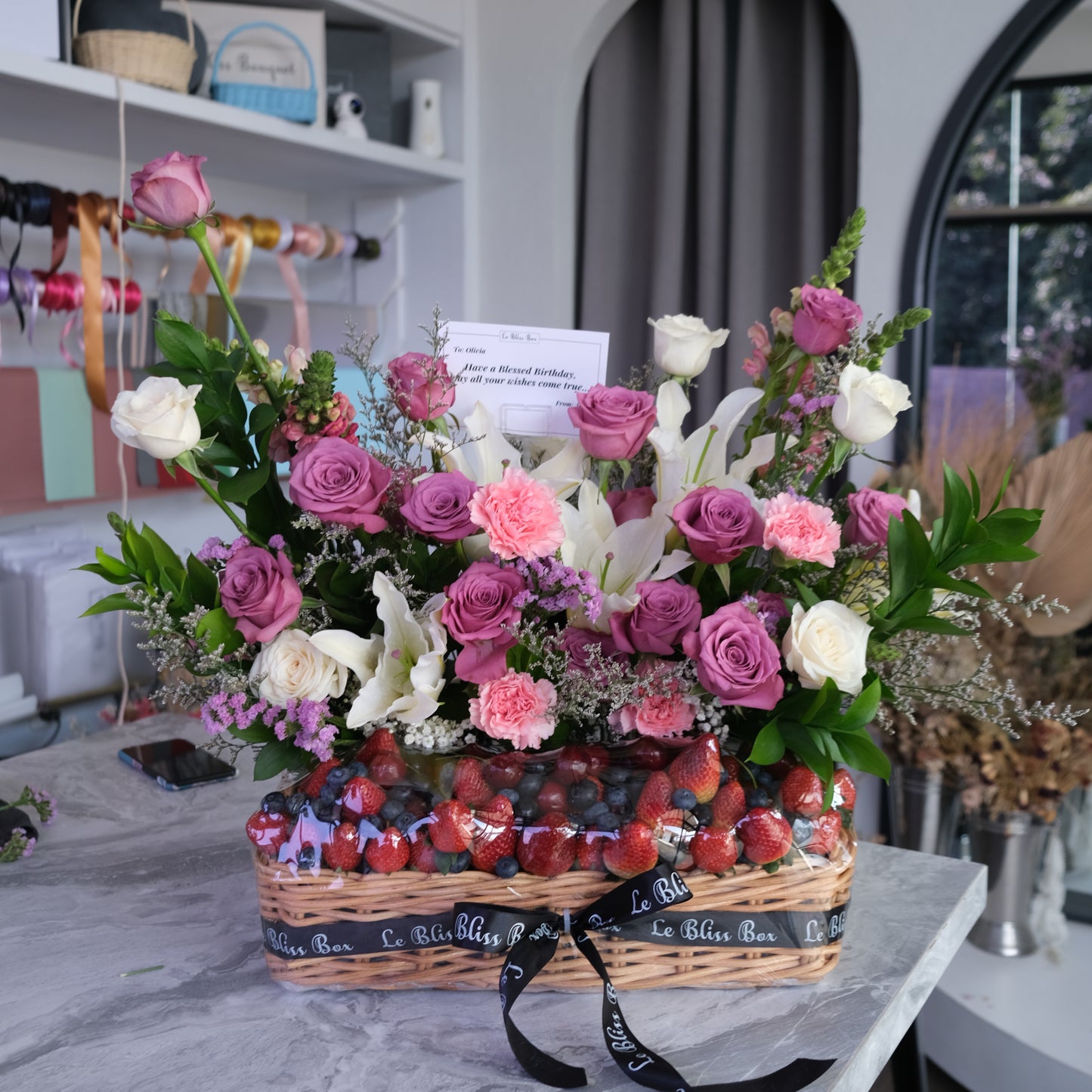 Mixed Berries with fresh flowers in a rattan basket by le bliss box. Jakarta, Tangerang, Surabaya, Cirebon delivery, pengiriman parcel buah cepat