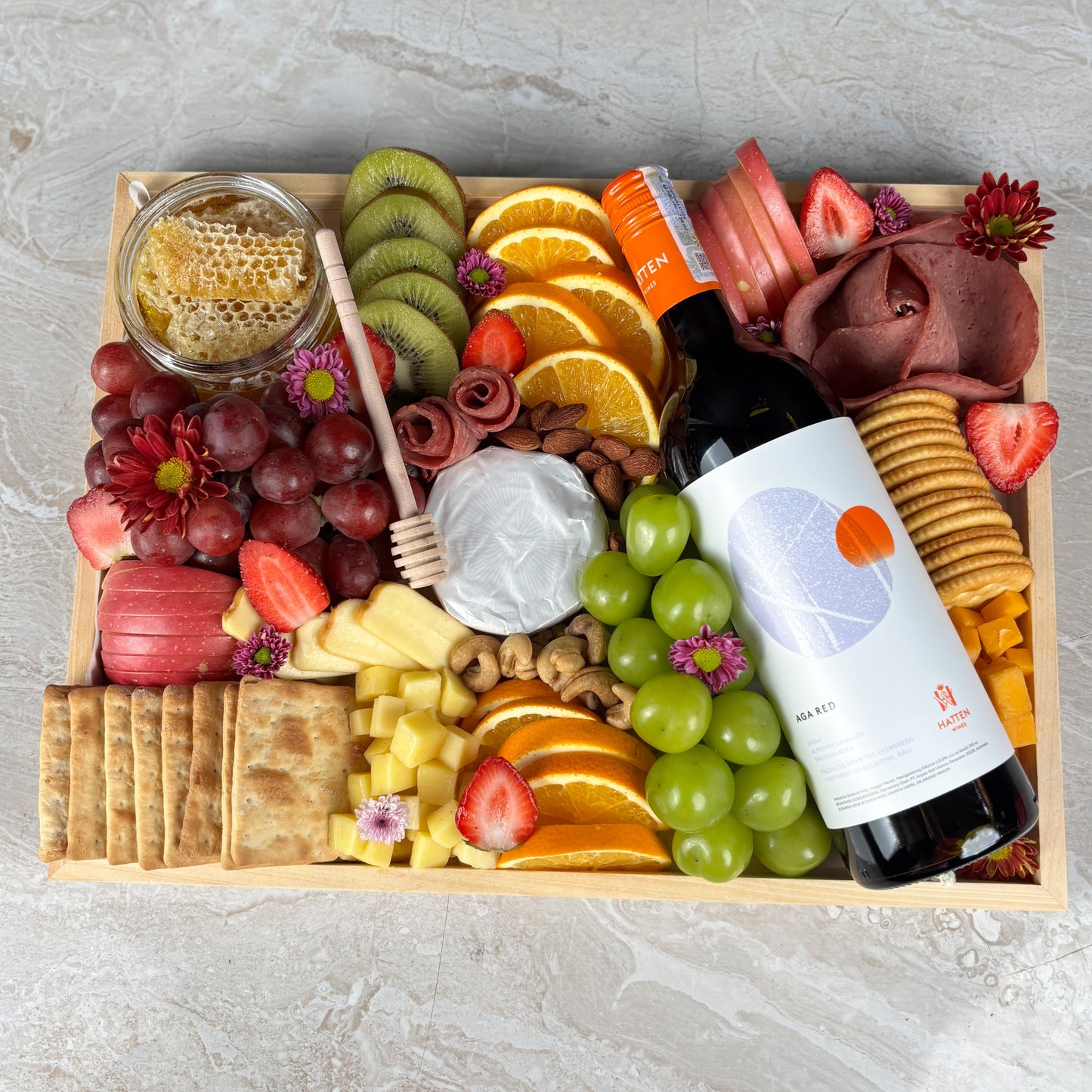 Red wine cheese platter on wooden tray with fruits and cheeses by le bliss platter