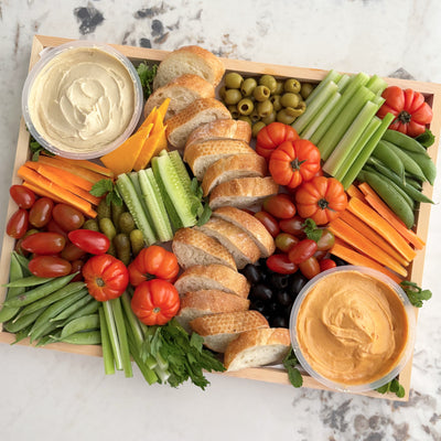 crudite platter jakarta assorted vegetables, bread, and two types of dip on a marble surface. Le Bliss Platter’s Double Hummus Crudités Platter available in Jakarta & Surabaya.