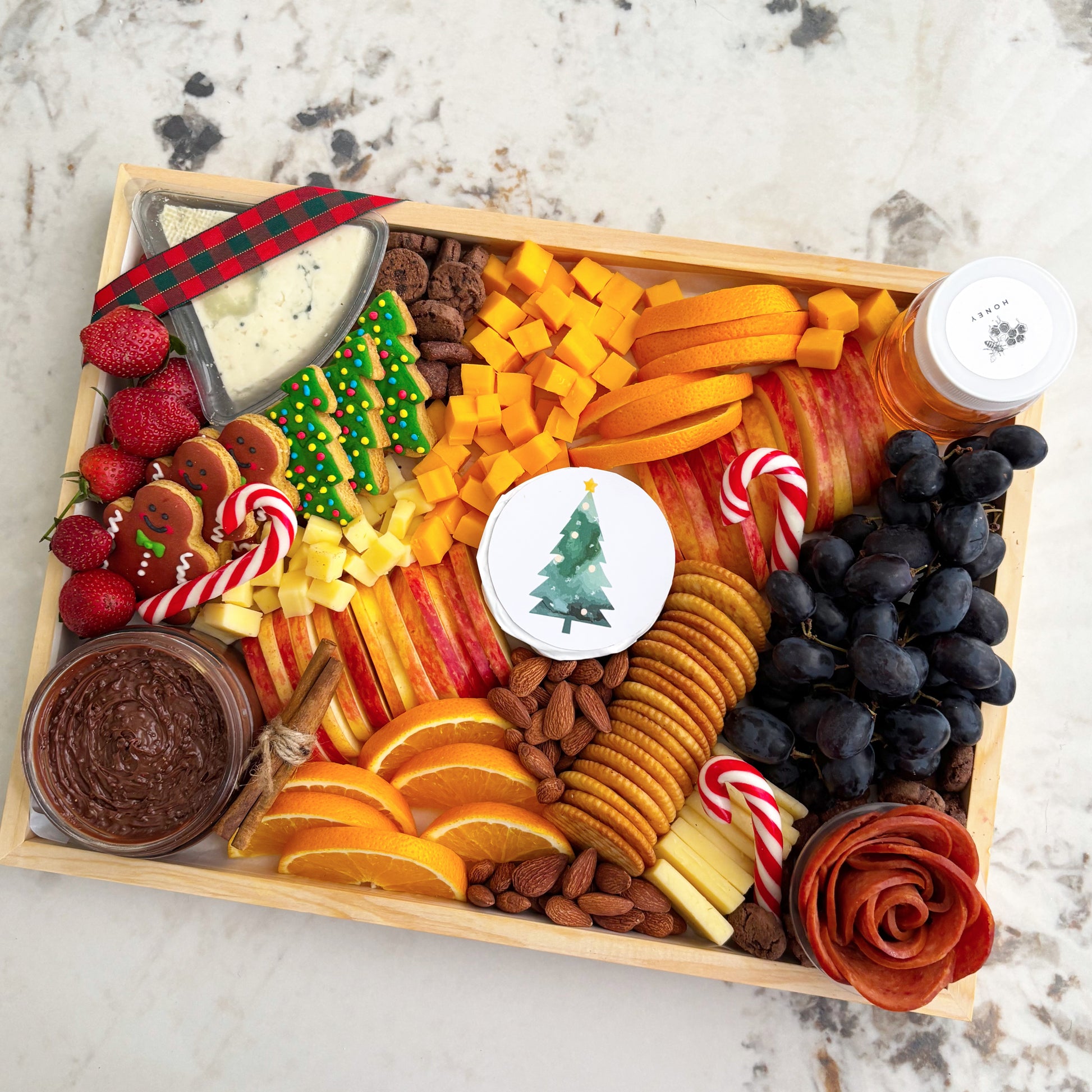  festive charcuterie board with fruits, cheese, and other treats on a marble surface.  Christmas Xtra Cheese Platter | Best Cheese Platter in Jakarta & Surabaya – Le Bliss Platter