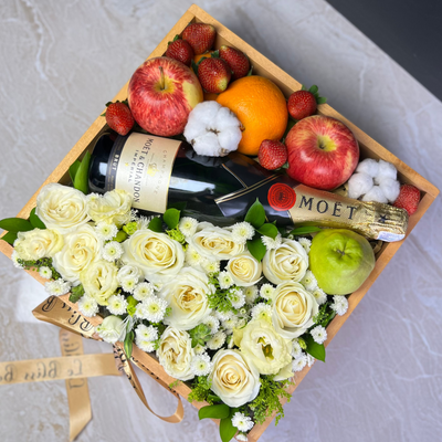 moet hamper jakarta, with flowers, fruits, and a bottle of Moët champagne on a marble surface. Wine hamper jakarta, wine hamper surabaya, tangerang, depok, bekasi, bogor by le bliss