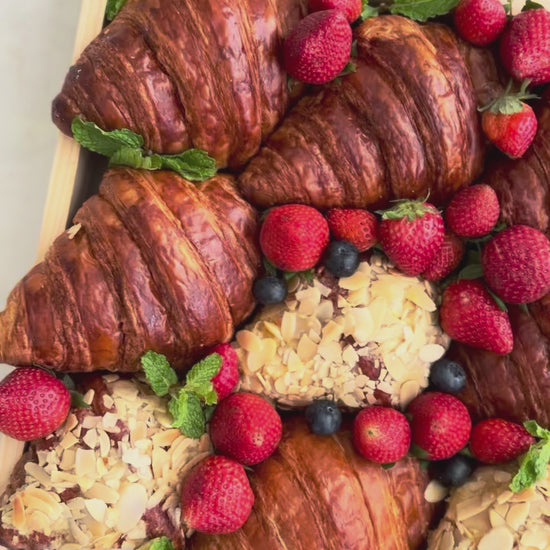 Box of croissants and pastries with berries on a marble surface. best platter in jakarta, best platter in surabaya