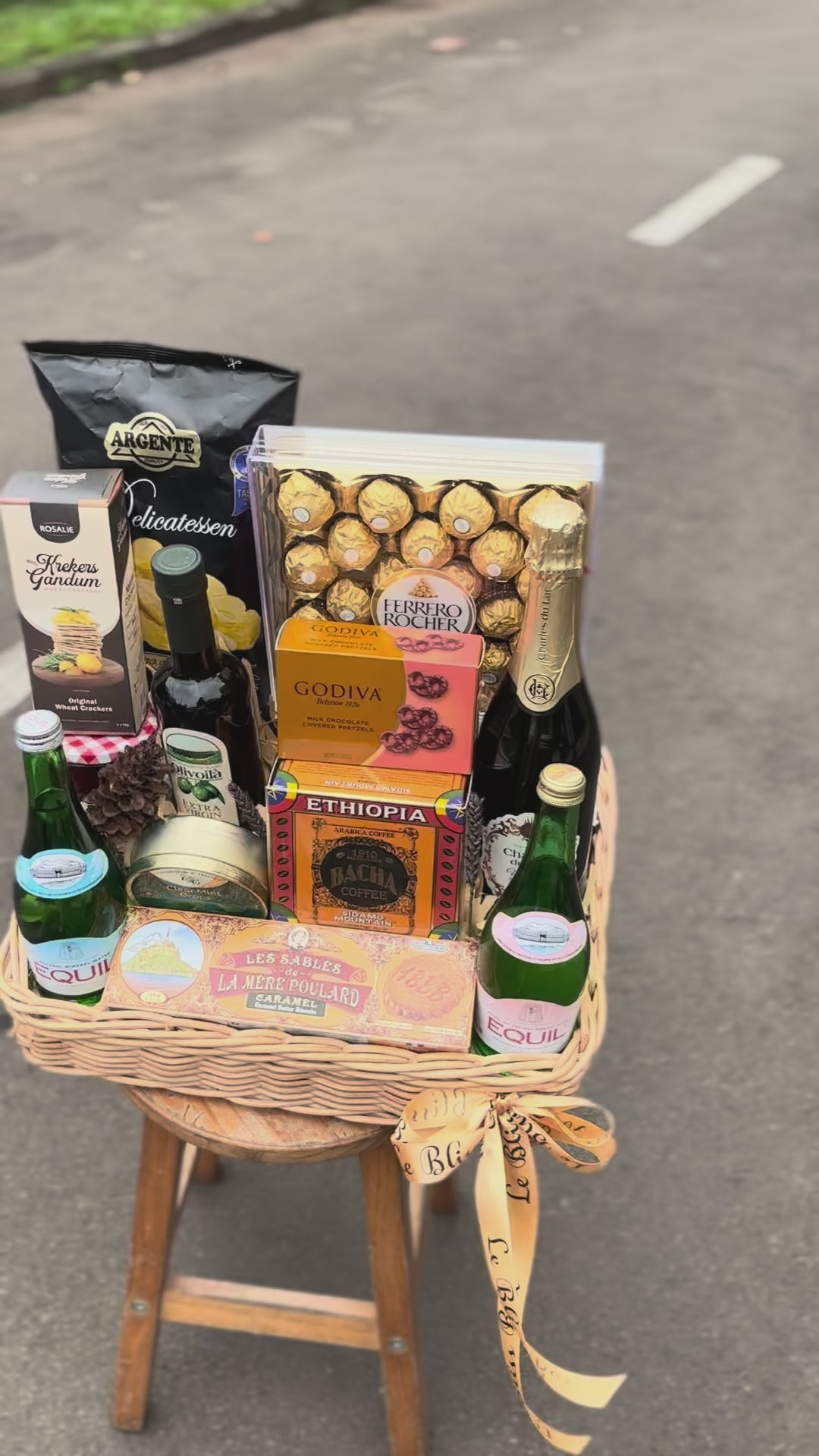 Gift basket with snacks, drinks, and chocolates on a dark surface. hamper jakarta, hamper surabaya, gourmet hamper jakarta