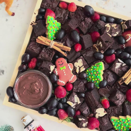 Chocolate brownie platter with berries, cookies, and dips on a wooden board with Christmas decorations. Xtra Christmas Brownies Platter | Christmas Platter Jakarta & Surabaya – Le Bliss Platter