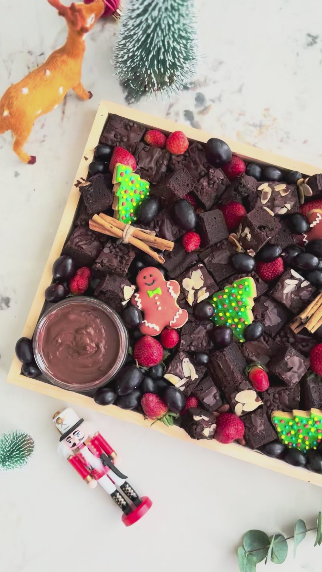 Chocolate brownie platter with berries, cookies, and dips on a wooden board with Christmas decorations. Xtra Christmas Brownies Platter | Christmas Platter Jakarta & Surabaya – Le Bliss Platter