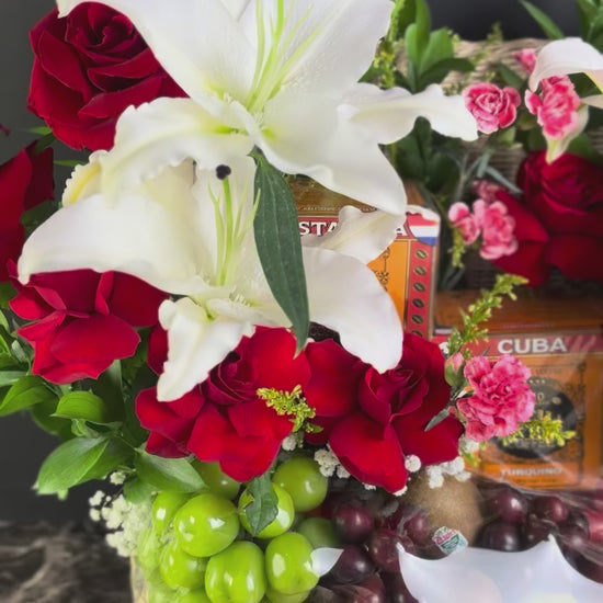 Floral arrangement in a basket with fruits and a box of bacha coffee on a dark surface, bacha coffee hamper surabaya, jakarta, tangerang. cirebon