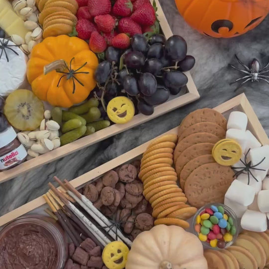 Halloween-themed charcuterie board with various treats and decorations on a dark surface. halloween platter jakarta, halloween platter surabaya