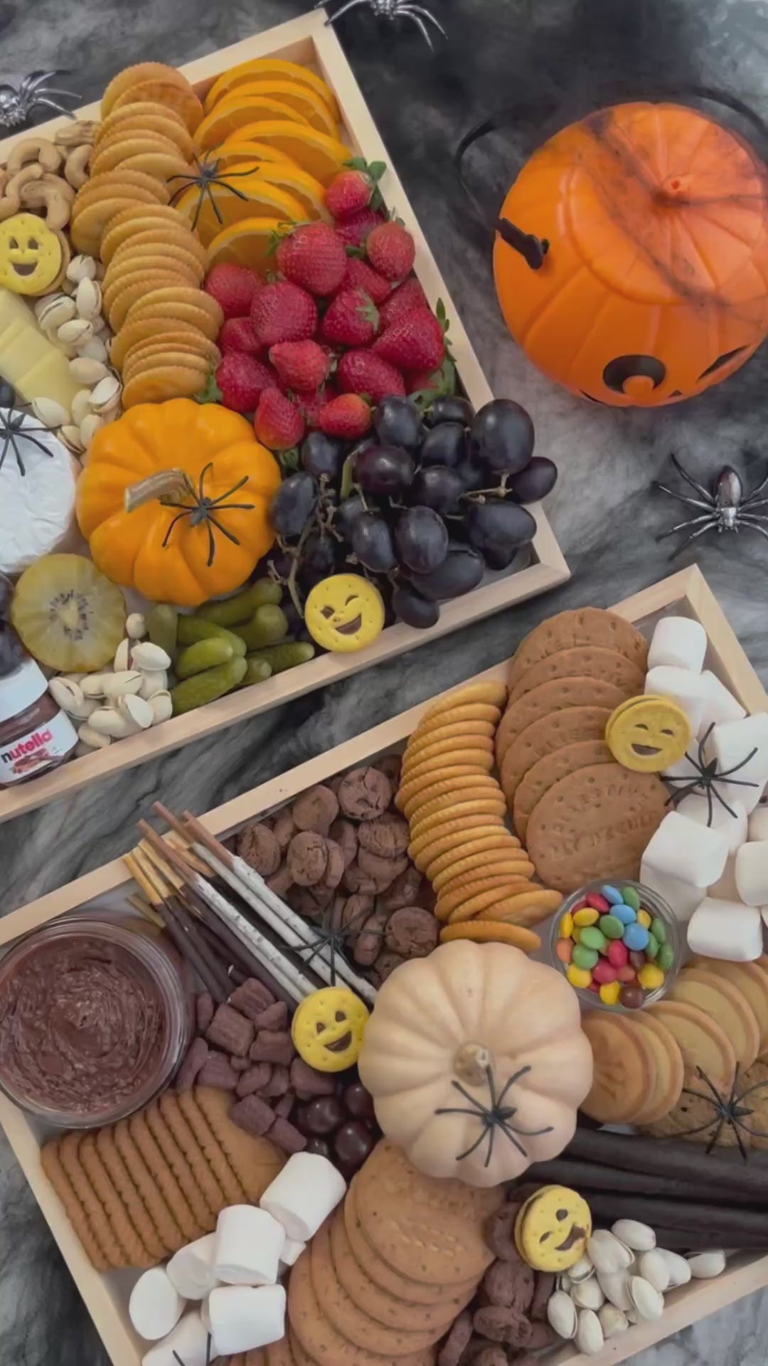 Halloween-themed charcuterie board with various treats and decorations on a dark surface. halloween platter jakarta, halloween platter surabaya